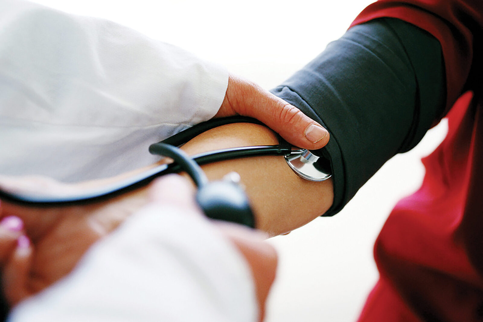 Doctor Checking the Blood Pressure of a Patient --- Image by © Royalty-Free/Corbis